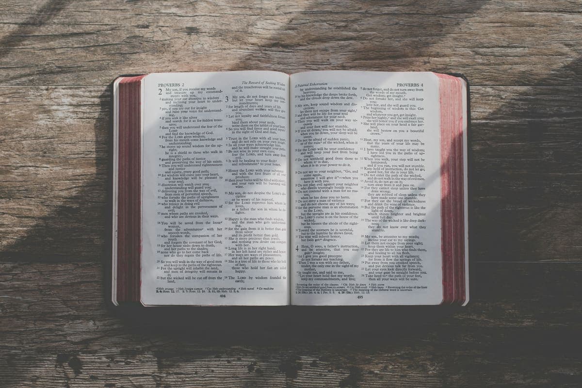 An open Bible resting on a wooden table